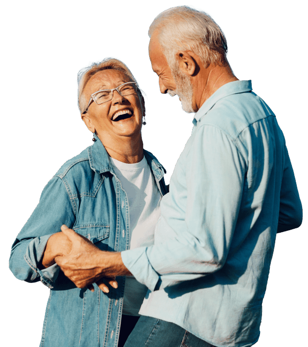 Happy elderly couple laughing and holding hands