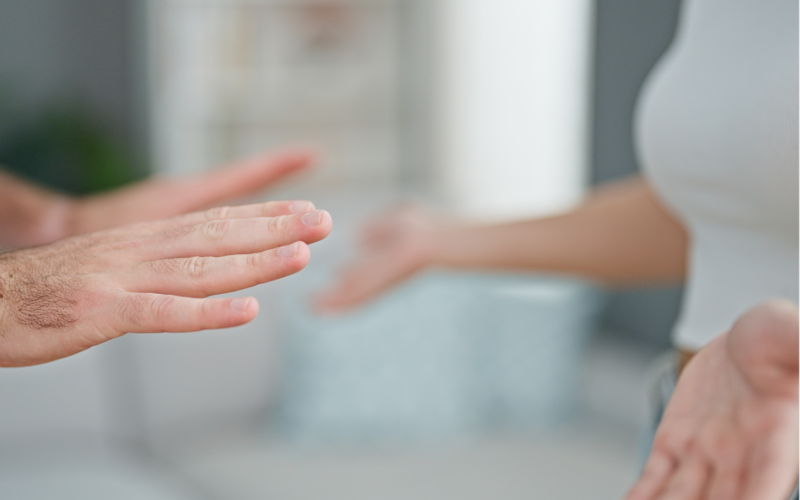 Two people's hands indicate that they are in a disagreement