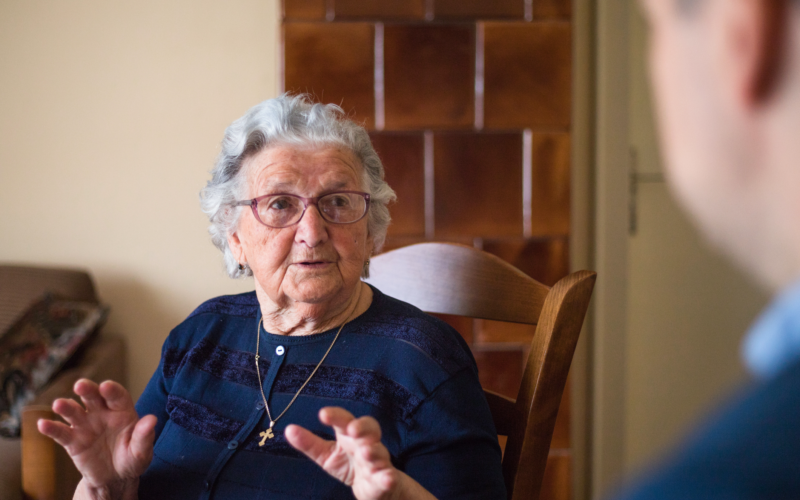 An older woman having a conversation